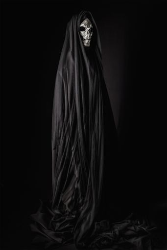 A portrait of a reaper with a skull face draped in a black gown, looming ominously against a pitch-dark backdrop, encapsulating the of Halloween