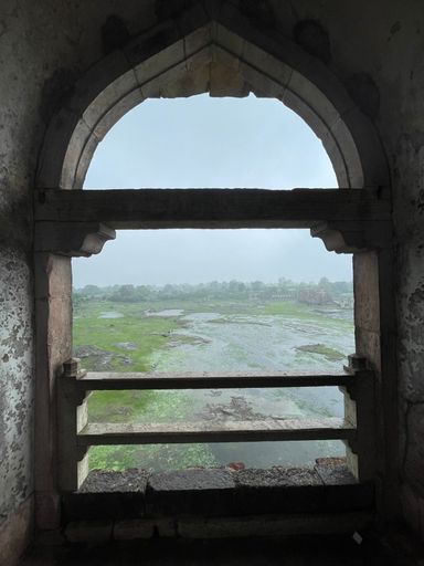 A stunning view from the inside of a window, framed by a white wooden frame