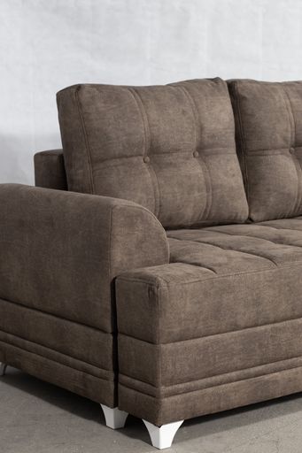 A vertical shot of a grey drape sofa