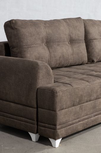 A vertical shot of a grey drape sofa