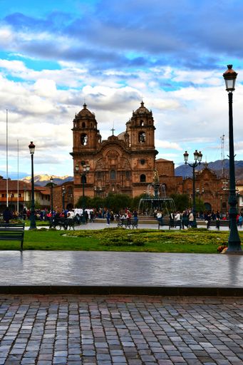 The busy Plaza de Armas in Cusco during a normal day-life with all the people/tourists walking around or sitting to see the life pass by.