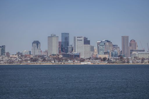 A stunning aerial view of the Boston city skyline with Boston harbor in the foreground
