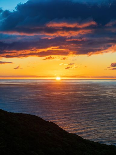 Sunset over Tasman sea at Piha beach, Auckland, New Zealand