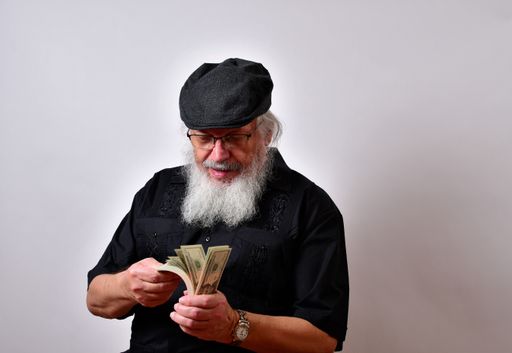 Money with beard counting his money while standing on the white background
