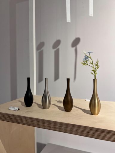 A tabletop display featuring an assortment of decorative vases in a range of colors