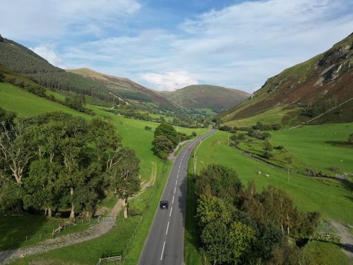 Aerial view of a lush, rural landscape, taken from a high viewpoint looking down on the terrain