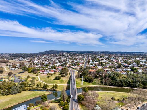 An aerial view of a bridge on a river at Inverell, New South Wales, Australia on a sunny day
