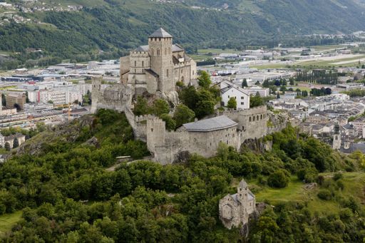 An aerial view of Basilique de Valere in Sion, Switzerland, with a stunning landscape in the background
