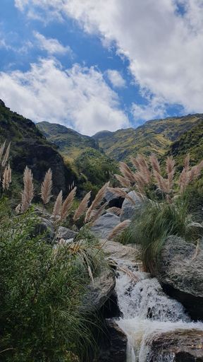 A powerful waterfall cascading down into a lush, green valley