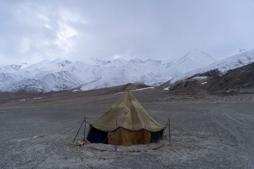 A camping tent on a snowy mountainside