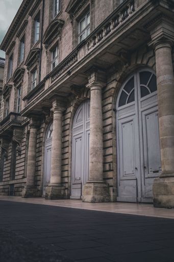 An old building with large windows and doors