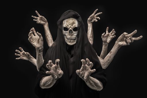 Halloween concept of portrait of grim reaper with eight hands isolated on dark background