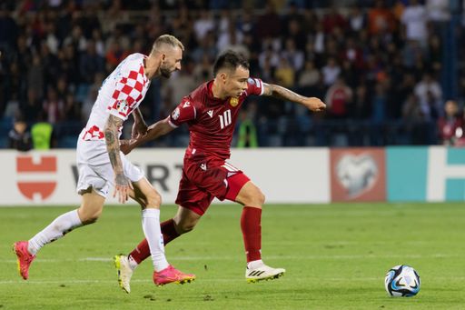 The soccer players compete during a football match between Croatia and Armenia's national teams