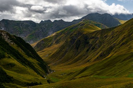 A stunning mountain range with rolling hills and lush green grass carpeting the landscape, Georgia