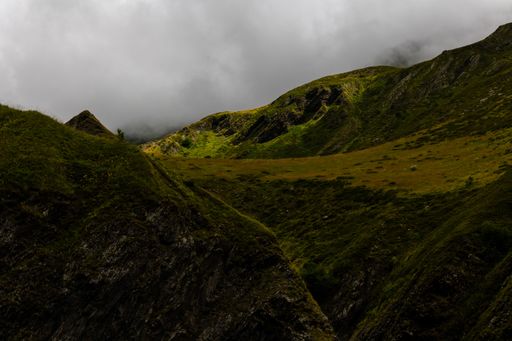 A stunning mountain range with rolling hills and lush green grass carpeting the landscape, Georgia