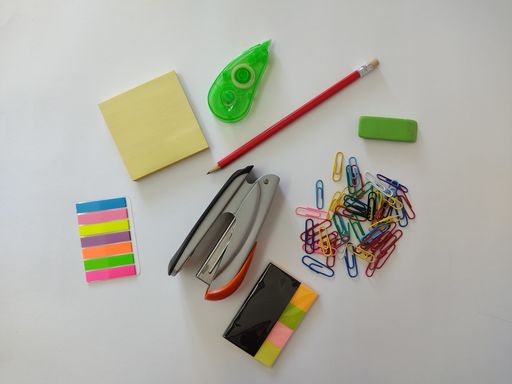 A top view of office supplies isolated on white background