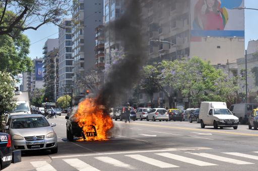 street downtown Belgrano, Buenos Aires, with a burning car