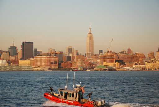 NYFD boat on Hudson River with view to Manhattan skyline, New York