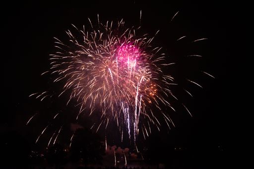 A vibrant display of fireworks lights up the night sky, creating a beautiful scene of dazzling colors