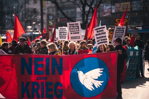 Anti war and anti military protest in Germany. German banners translate into pro peace statements. Thousands of people in the streets