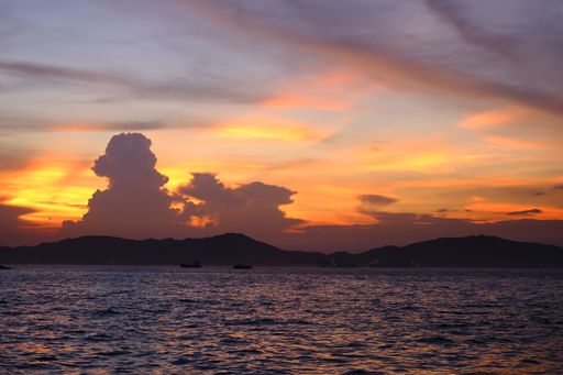 This stunning image features a breathtaking sunset with an idyllic sky reflecting off the tranquil waters below