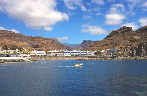 General view of the beach at Playa de Mogan, Gran Canaria, Spain, seen from the sea at a short distance.