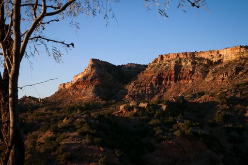 A beautiful landscape of desert mountains illuminated by the golden sunlight of dusk