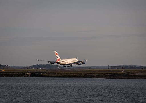 A British Airways plane depicted in the process of taking off from a body of water