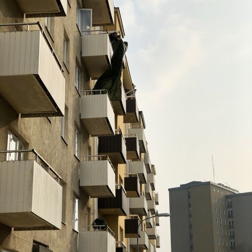 A vertical shot of a modern building with balconies