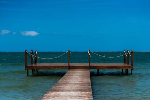 A small wooden dock leading out into the ocean