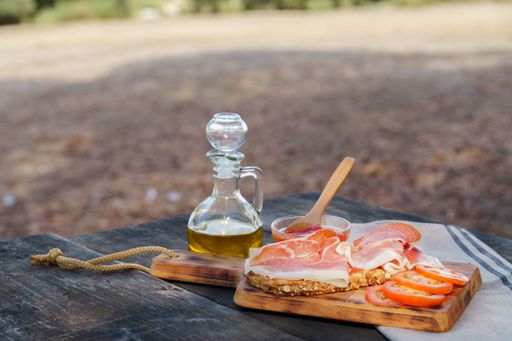An acorn-fed typical Spanish toast of bread with tomato, olive oil and ham for picnic