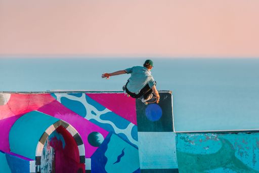 An active young man performing a skateboarding trick on a ramp in Morocco