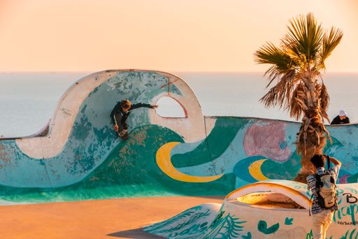 A closeup of a  young man on a skateboard  performing a trick on a ramp in Morocco
