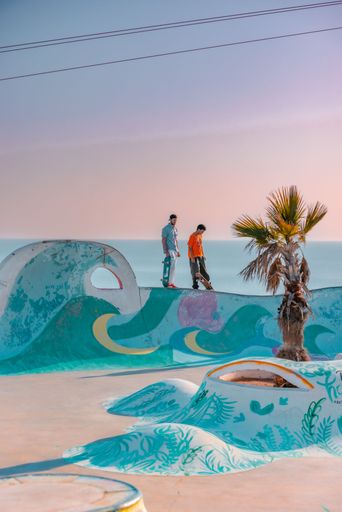 A closeup of a  young man on a skateboard  performing a trick on a ramp in Morocco