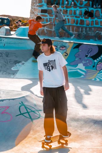 A closeup of a  young man on a skateboard  performing a trick on a ramp in Morocco