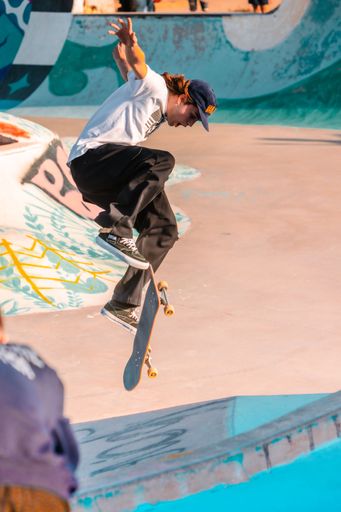 A closeup of a  young man on a skateboard  performing a trick on a ramp in Morocco