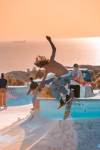 A closeup of a  young man on a skateboard  performing a trick on a ramp in Morocco