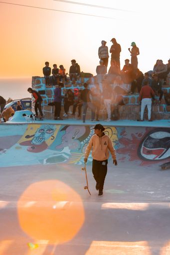 A closeup of a  young man on a skateboard  performing a trick on a ramp in Morocco