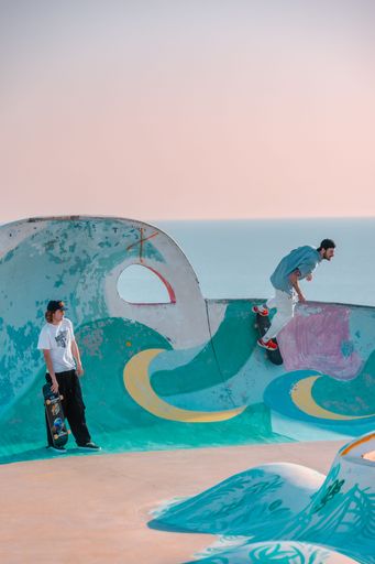 A closeup of a  young man on a skateboard  performing a trick on a ramp in Morocco