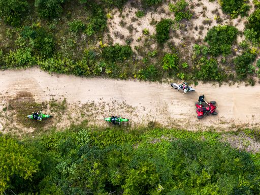 An aerial top view of dirt bikes, and a red quad motorcycle in Gerritsen Beach, Brooklyn in New York