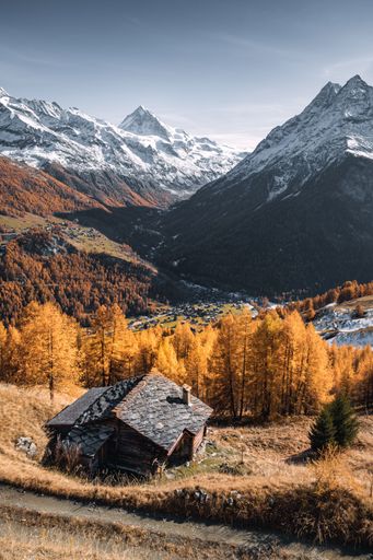 Landscape view of a typical Swiss chalet with a view on the Val d'Herens valley in autumn