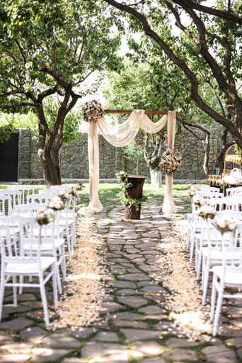 This image features a stunning outdoor wedding ceremony in a garden setting