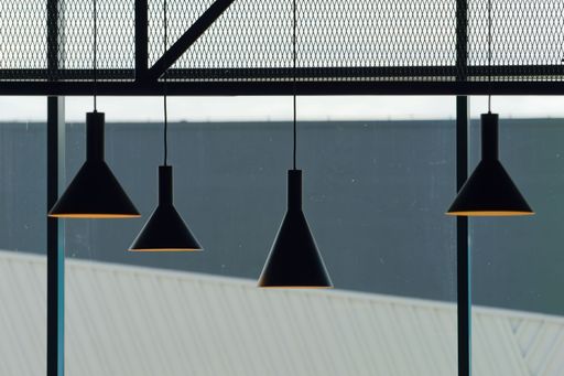 An inviting interior featuring a contemporary design, with a ceiling adorned with hanging pendant lights