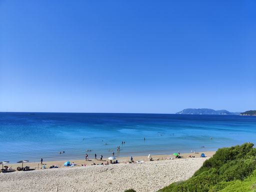 A group of people having fun in the crystal-clear waters of the ocean at a picturesque sandy beach