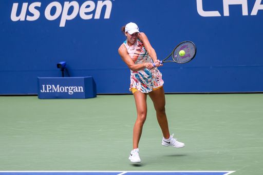 An athletic woman playing tennis on a court in the US Open 2023 tournament