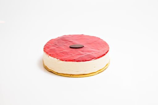 A closeup shot of a gourmet raspberry cheesecake isolated on a white surface