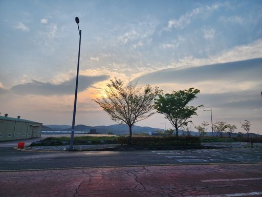 A parking lot blanketed in the golden light of a magnificent sunset