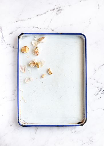 White Enamel Roasting Pan with Garlic and Copy Space