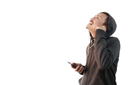 A man wearing a hoody jacket and using earphones isolated on a whitbackground