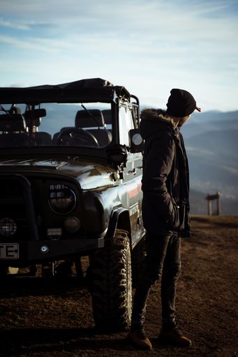 A young man by his pickup truck admiring the view from the mountaintop
